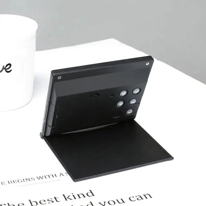 Réveil numérique pliable noir avec affichage multifonction -  - reveil-de-voyage-pliable - ["digital","num\u00e9rique","petit reveil","plastique","r\u00e9veil digital","simple","voyage"]